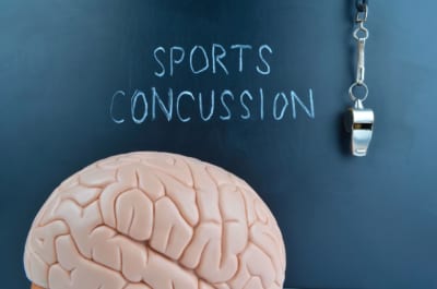 Concussion - Graphic showing a brain and a sports whistle
