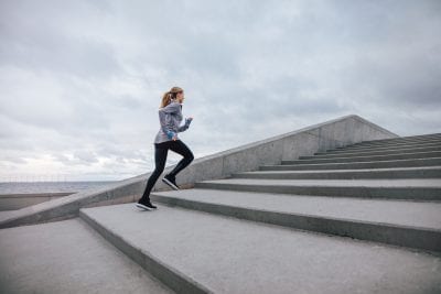 Gluteal muscles - A woman running up stone steps