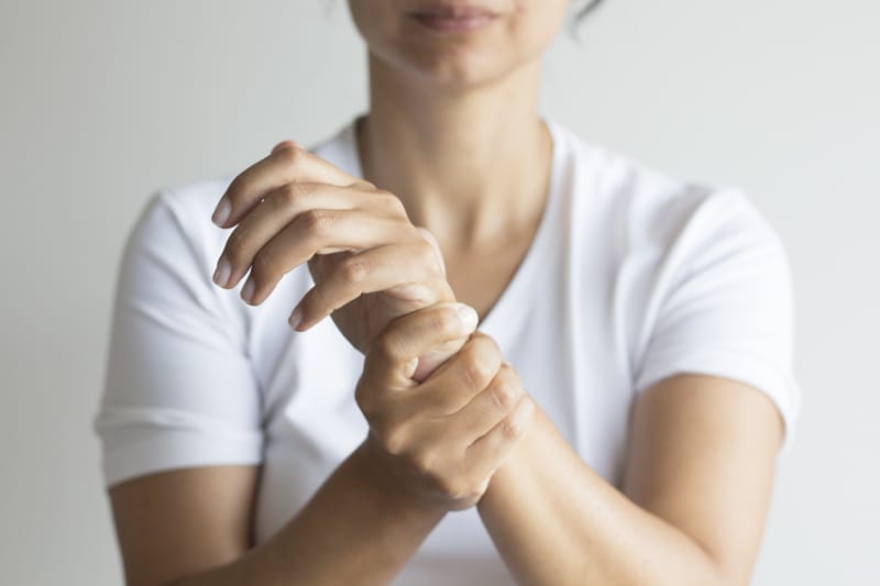 Wrist - A woman holding her wrist