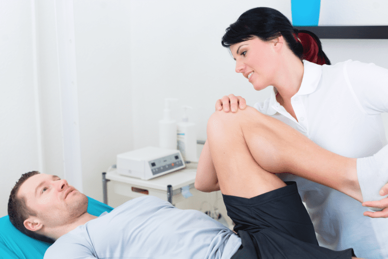 Bio-Psycho-Social - A physiotherapist working on a male patient