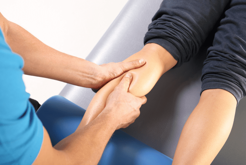 massage - A physiotherapist massaging the leg of a female