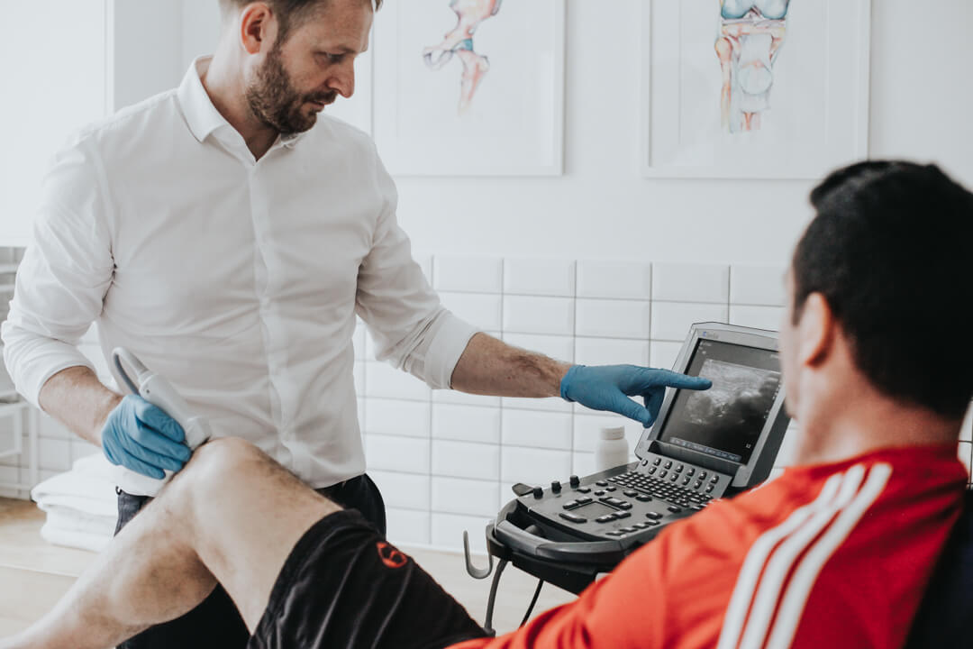 Physiotherapist performing ultrasound scan of knee